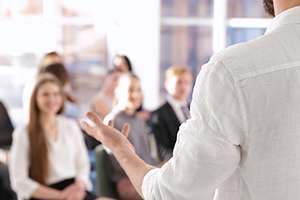 Teacher giving a class to his students