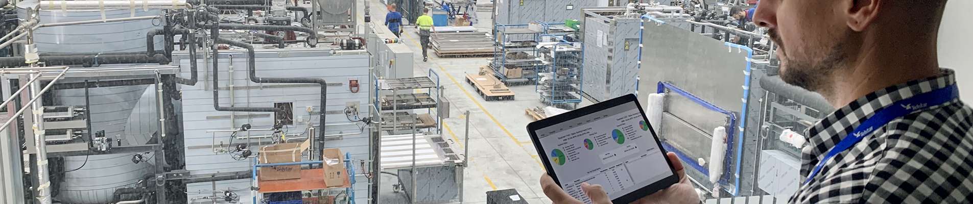 A man validating on a tablet inside a facility.