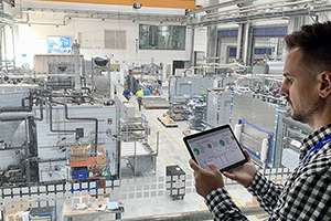 A man validating on a tablet inside a facility.