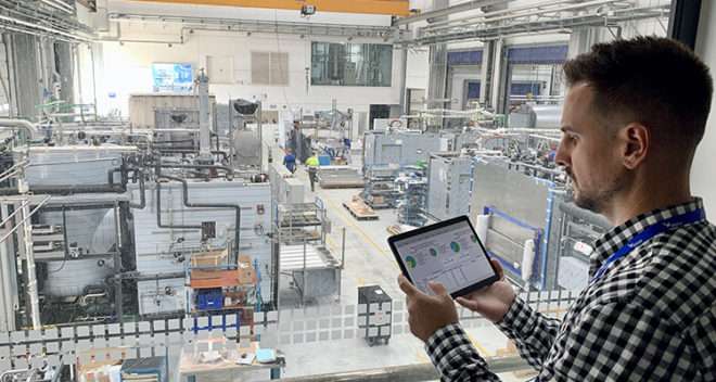 A man validating on a tablet inside a facility.